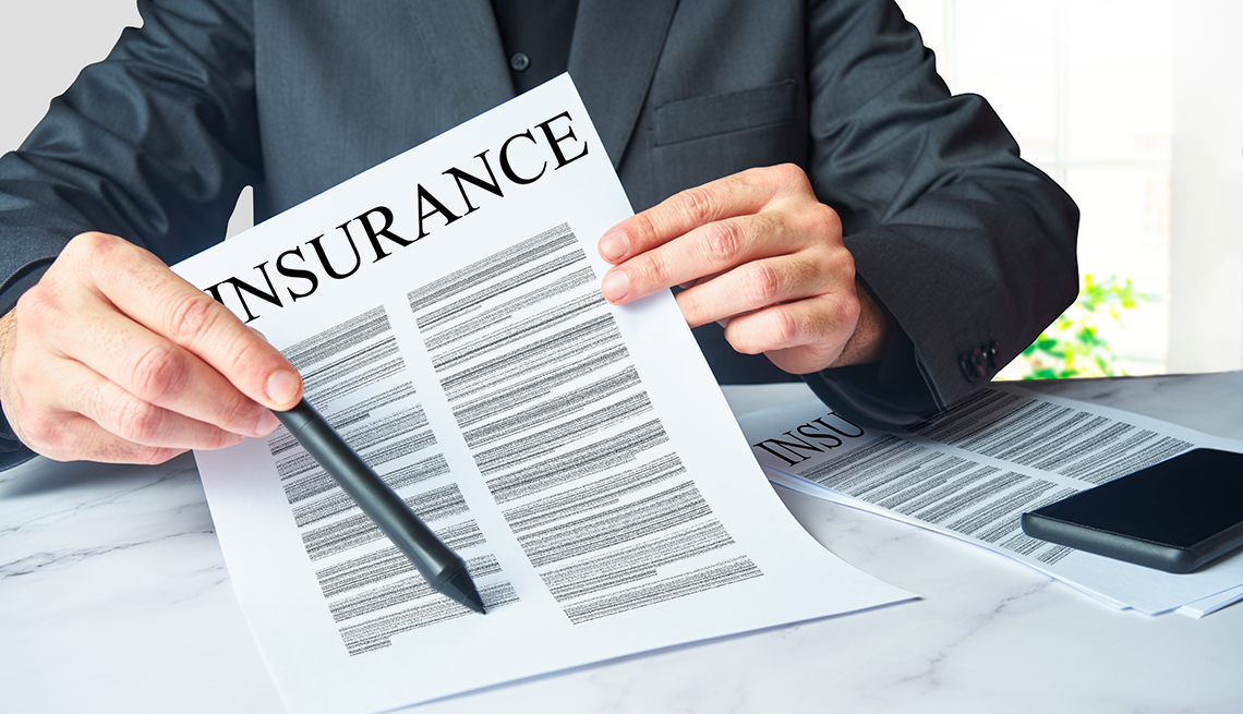 An insurance agent is presenting a policy contract  for an unsee